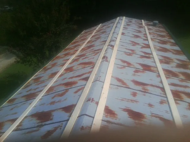 Rusted metal roof panels with new wood purlins before replacement — Storm Damage Roof Repair in Kunkletown by Roofing Brothers